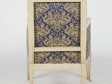 an old chair with a blue and gold patterned upholstered seat