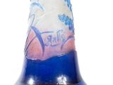 a blue and white vase with a picture of a woman on it
