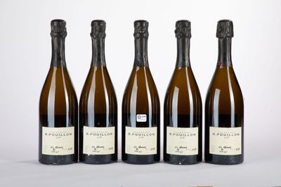 quatre bouteilles de vin sont alignées sur une table