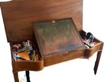 a small wooden desk with a drawer on top of it