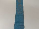 a blue scarf hanging on the wall with a gold star on it