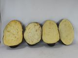 four pieces of potato sitting next to a knife on a table