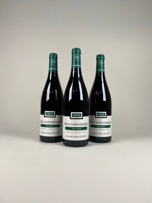 trois bouteilles de vin posées sur une table blanche
