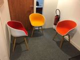 three chairs in the corner of a room with a fire extinguisher in the background