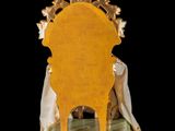 a statue of a woman sitting on top of a chair