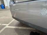 a close up of a car ' s bumper with a hole in it