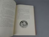 an open book with a drawing of a man reading a book