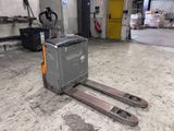 a forklift in the middle of the floor in a warehouse