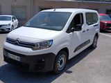 a white van parked in a parking lot next to other cars