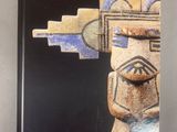 the cover of a book with an image of a wooden figure on it