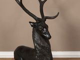 an image of a statue of a deer laying down on the floor