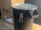 a black pot sitting on a wooden table next to a box