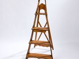 a wooden ladder that is standing up against a wall