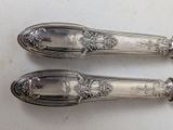 two spoons that are sitting on a table