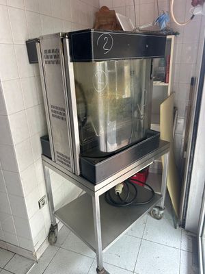 a machine that is sitting on a cart in the kitchen