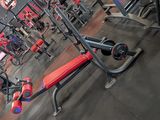 an image of a gym with a bench and weights