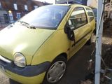 a small yellow car that is parked in a lot
