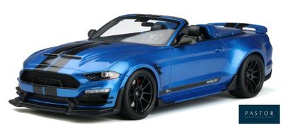 the blue ford mustang convertible is parked on a white surface