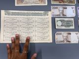 a person holding a piece of paper with a lot of money on it