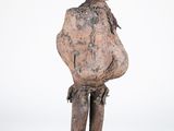 an old wooden statue of a man with a hat on his head