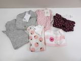 a lot of baby clothes that are on a table