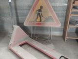 a pink forklift with a sign on it in a garage