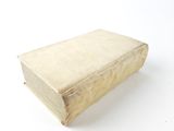 an old book sitting on a white surface with a white background