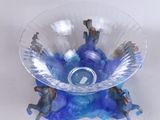 a glass bowl with a ring in it sitting on a table