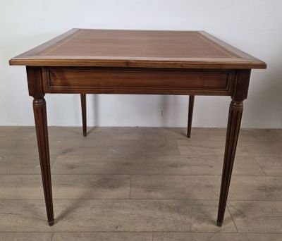 a wooden table with a drawer underneath it on a wooden floor