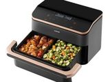 a black and gold air fryer with food in it