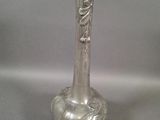 a silver vase that is sitting on a table