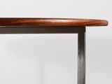 a close up of a table with a wooden top and metal legs