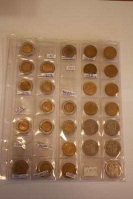 a lot of coins that are in a plastic case