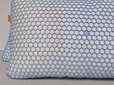 an image of a blue and white pillow on a white surface