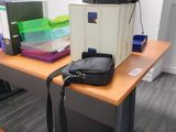 a bag sitting on top of a desk next to a computer monitor