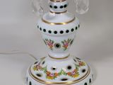 a white table lamp with a floral design on it