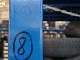 a blue pole with a sign on it in a warehouse