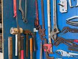many different types of tools hanging on the wall