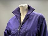 a mannequin wearing a purple jacket with a zipper
