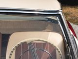 a dog sitting in the driver ' s seat of a car