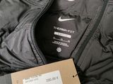 the jacket is black and has a price tag on it