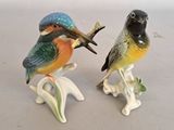 two figurines of birds sitting on top of each other