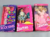three barbie dolls are sitting in a box on a table