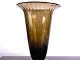 a glass vase that is sitting on a black table
