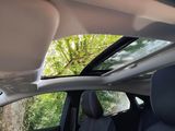 a view of the sunroof from inside of a car