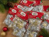 many bags of christmas candy sitting on a table