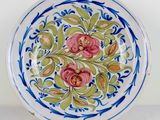 a blue and white plate with pink flowers on it