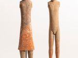 two statues of a man and a woman standing next to each other