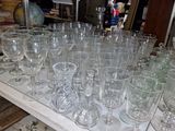 many glasses and plates on a shelf in a room