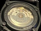 a close up of a watch on a black background